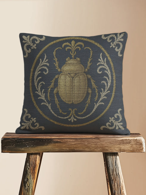 square woven tapestry pillow in charcoal grey and metallic gold thread, embodying a premium, artisan feel. The central design features a large, detailed scarab beetle, a key motif in entomology decor, encircled by ornate Victorian botanical flourishes. This combination of scholarly and mystical elements is ideal for Dark Academia, Gothic, and Whimsigoth aesthetics. The luxurious, double-sided piece of functional art is perfect as a statement pillow for a library or reading nook.